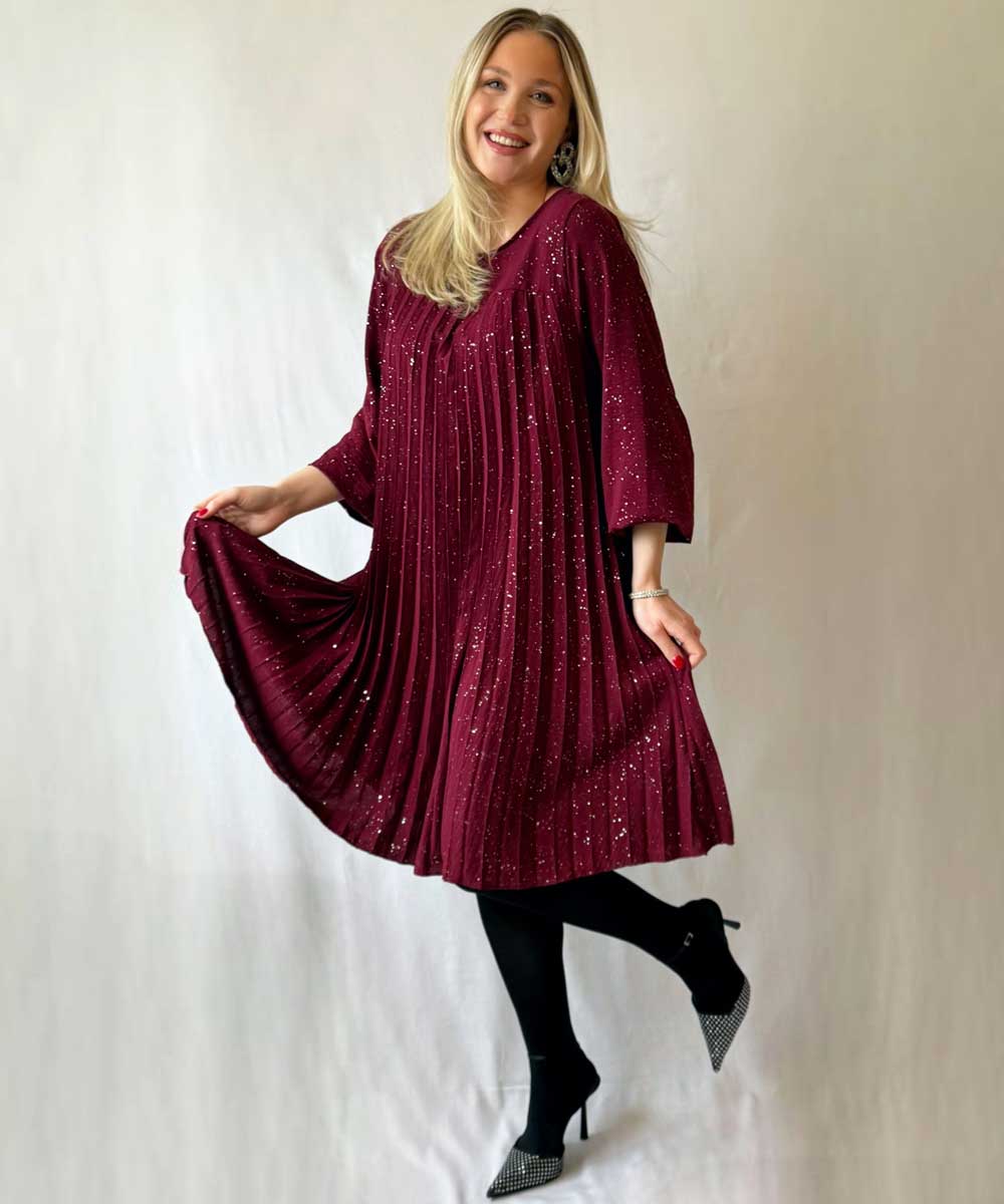 Modell i vinröd glitterklänning