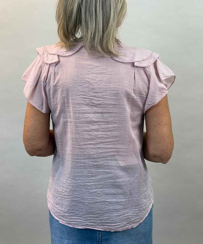 Rosa blus med volang baksida